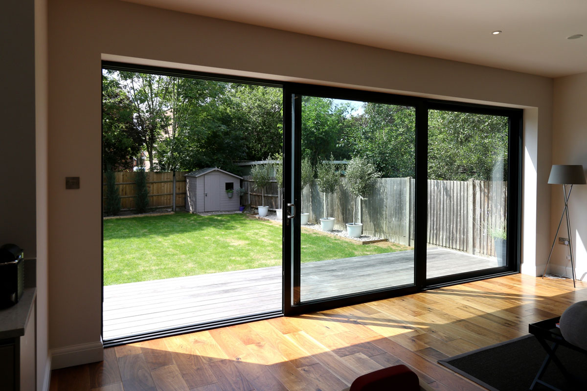 What are the advantages of installing aluminum sliding doors in homes and commercial spaces